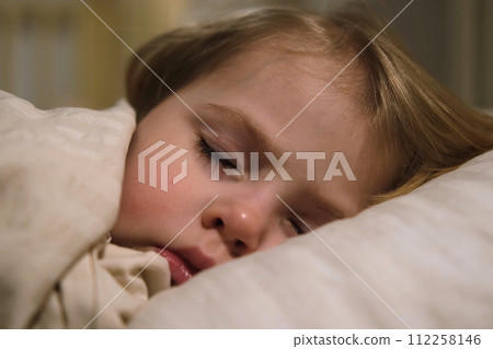 Child Falls Asleep. Peaceful Adorable Baby Sleeping at Home. Slumbering Little Toddler. Two Years Old Girl Sleeps. Nursery Room Interior Background. Serene Dream. Cute Face Close Up. Deep Kid Slumber Child Falls Asleep. Peaceful Adorable Baby Sleeping at Home. Slumbering Little Toddler. Two Years Old Girl Sleeps. Nursery Room Interior Background. Serene Dream. Cute Face Close Up. Deep Kid Slumber 112258146