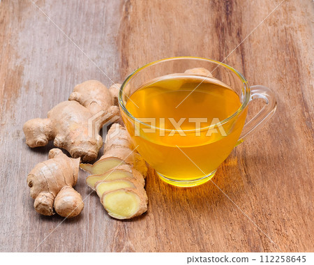 Ginger tea on wooden table Ginger tea on wooden table 112258645