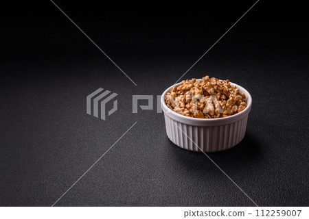 Delicious fresh peeled raw walnuts in a ceramic plate Delicious fresh peeled raw walnuts in a ceramic plate 112259007