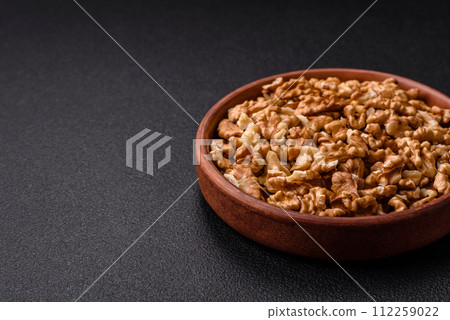 Delicious fresh peeled raw walnuts in a ceramic plate 112259022