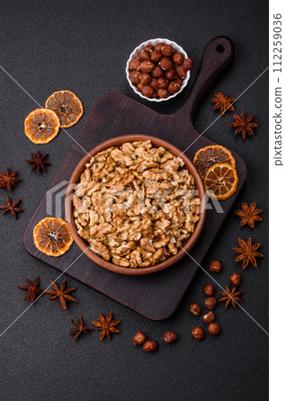 Delicious fresh peeled raw walnuts in a ceramic plate Delicious fresh peeled raw walnuts in a ceramic plate 112259036