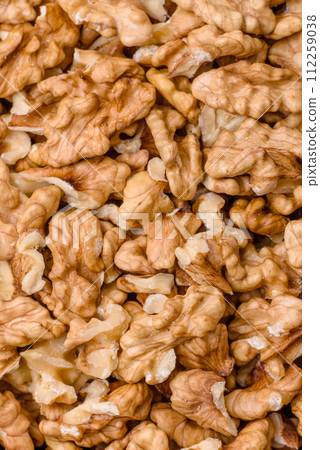 Delicious fresh peeled raw walnuts in a ceramic plate Delicious fresh peeled raw walnuts in a ceramic plate 112259038