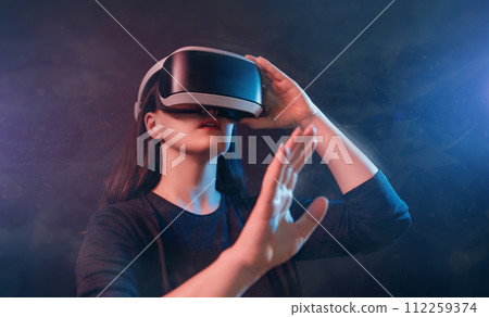 Woman with VR virtual reality goggles Woman with VR virtual reality goggles 112259374
