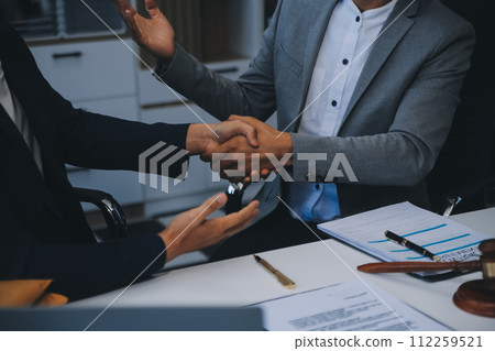 Consultation and conference of Male lawyers and professional businesswoman working and discussion having at law firm in office. Concepts of law, Judge gavel with scales of justice. 112259521