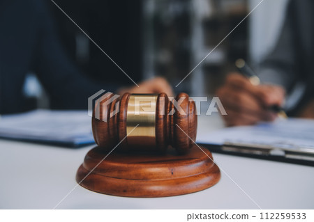 Consultation and conference of Male lawyers and professional businesswoman working and discussion having at law firm in office. Concepts of law, Judge gavel with scales of justice. Consultation and conference of Male lawyers and professional businesswoman working and discussion having at law firm in office. Concepts of law, Judge gavel with scales of justice. 112259533