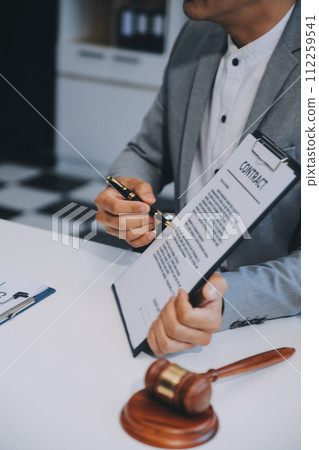 Consultation and conference of Male lawyers and professional businesswoman working and discussion having at law firm in office. Concepts of law, Judge gavel with scales of justice. 112259541