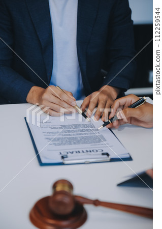 Consultation and conference of Male lawyers and professional businesswoman working and discussion having at law firm in office. Concepts of law, Judge gavel with scales of justice. 112259544