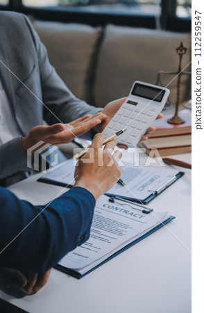 Consultation and conference of Male lawyers and professional businesswoman working and discussion having at law firm in office. Concepts of law, Judge gavel with scales of justice. 112259547