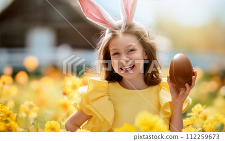 child with choco egg outdoors 112259673