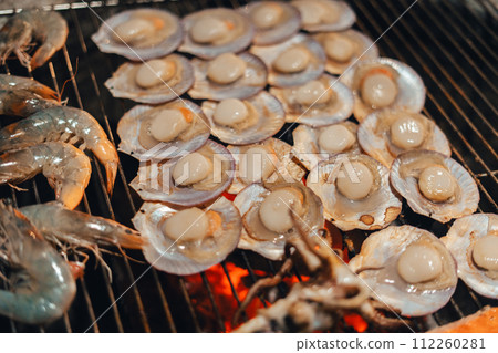 Scallops and shrimp grilled over charcoal grill Scallops and shrimp grilled over charcoal grill 112260281