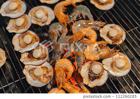 Scallops and shrimp grilled over charcoal grill Scallops and shrimp grilled over charcoal grill 112260285