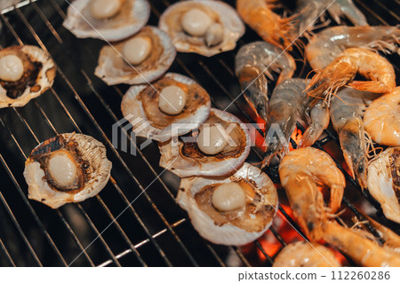 Scallops and shrimp grilled over charcoal grill Scallops and shrimp grilled over charcoal grill 112260286