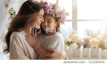 A mother and daughter are hugging each other. The daughter is we 112260450