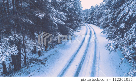 Road in a snowy pine forest in winter. View from above 112261035