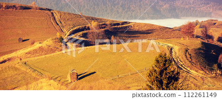 Top view of the colorful slopes of the mountains on an autumn sunny day. Carpathians, Ukraine. Horizontal banner; Top view of the colorful slopes of the mountains on an autumn sunny day. Carpathians, Ukraine. Horizontal banner; 112261149