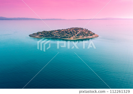 Small island covered with trees in tile lake in autumn. Aerial view. Gradient color Small island covered with trees in tile lake in autumn. Aerial view. Gradient color 112261329