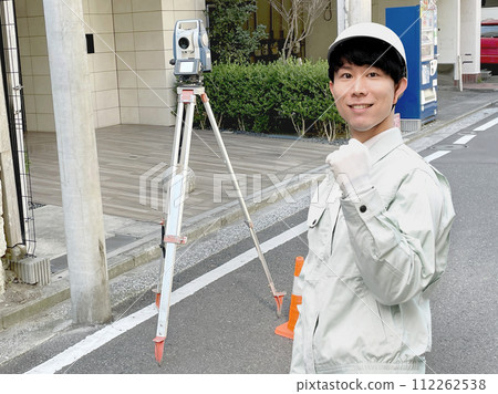 Asian male surveyor doing a fist pump outdoors Asian male surveyor doing a fist pump outdoors 112262538