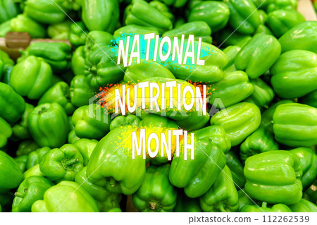 Vibrant Green Bell Peppers Emblazoned With National Nutrition Month Announcement 112262539