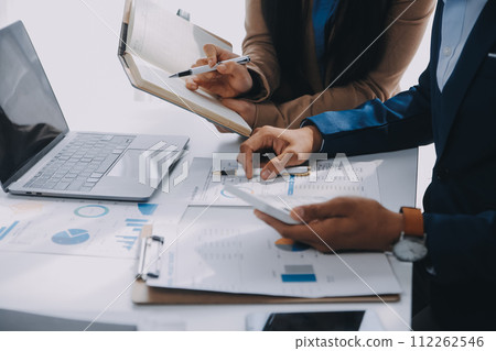 Business team working with new startup project plan and discussion information for financial strategy with laptop and digital tablet in a modern business lounge. 112262546