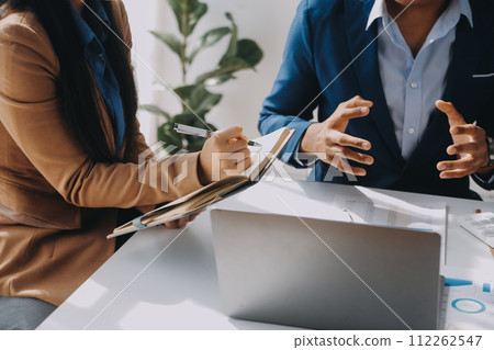 Business team working with new startup project plan and discussion information for financial strategy with laptop and digital tablet in a modern business lounge. 112262547