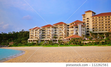 A tropical resort hotel bathed in the setting sun 112262561