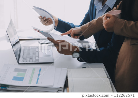 Business team working with new startup project plan and discussion information for financial strategy with laptop and digital tablet in a modern business lounge. 112262571