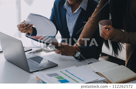Business team working with new startup project plan and discussion information for financial strategy with laptop and digital tablet in a modern business lounge. 112262572