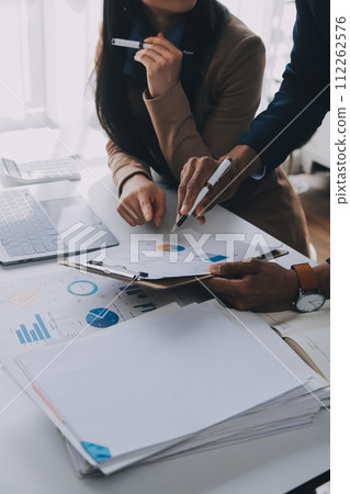 Business team working with new startup project plan and discussion information for financial strategy with laptop and digital tablet in a modern business lounge. 112262576