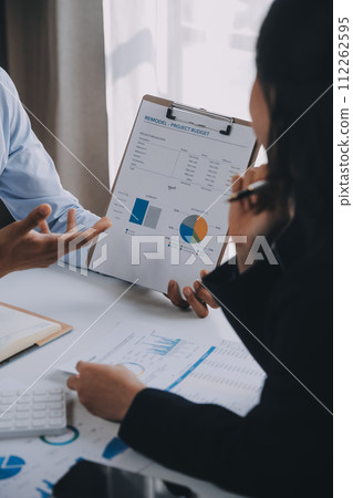 Business team working with new startup project plan and discussion information for financial strategy with laptop and digital tablet in a modern business lounge. 112262595
