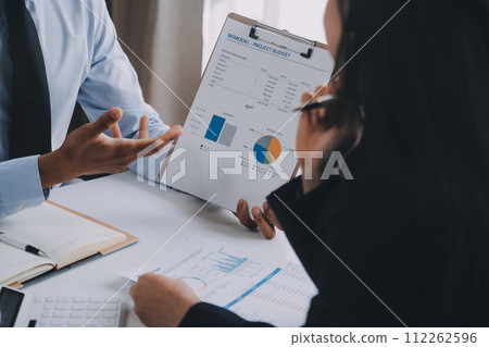 Business team working with new startup project plan and discussion information for financial strategy with laptop and digital tablet in a modern business lounge. 112262596