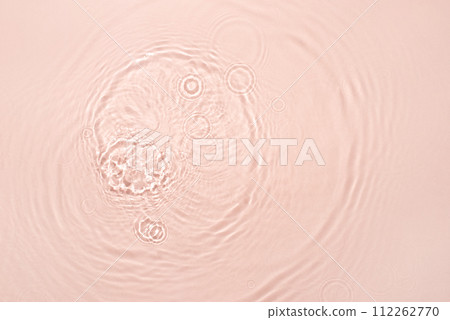 The texture of water on a pink background. The texture of water on a pink background. 112262770