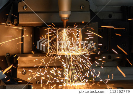Close up scene the fiber laser cutting machine cut the square shape stainless steel tube with sparkling light. Close up scene the fiber laser cutting machine cut the square shape stainless steel tube with sparkling light. 112262779