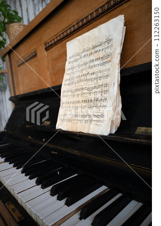 black old piano in cracks with notes black old piano in cracks with notes 112263150