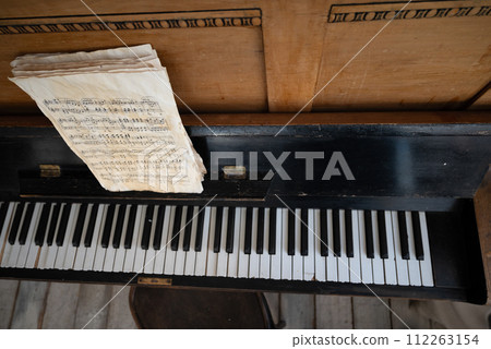 black old piano in cracks with notes 112263154