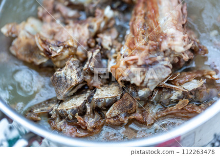 Bone and cartilage waste from butcher shops, heated dog food Bone and cartilage waste from butcher shops, heated dog food 112263478