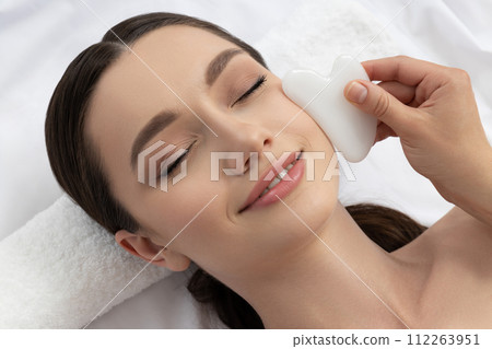 An attractive brunette at an appointment with a beautician 112263951