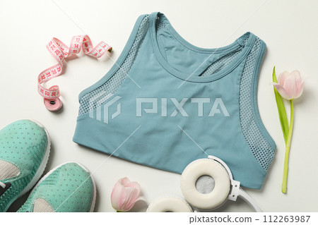 Sports top with headphones and flowers, on a light background. 112263987