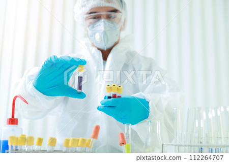 Researchers compare blood samples of patients infected with the disease in the laboratory. Researchers are inventing vaccines to treat COVID-19 virus. Researchers compare blood samples of patients infected with the disease in the laboratory. Researchers are inventing vaccines to treat COVID-19 virus. 112264707