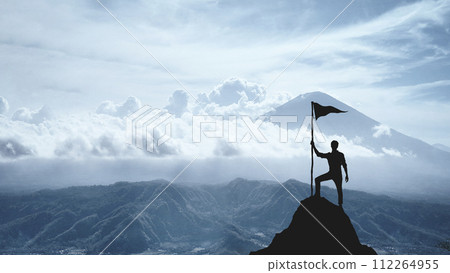 Silhouette of a man on the peak of a mountain, concept of victory and achievement Silhouette of a man on the peak of a mountain, concept of victory and achievement 112264955