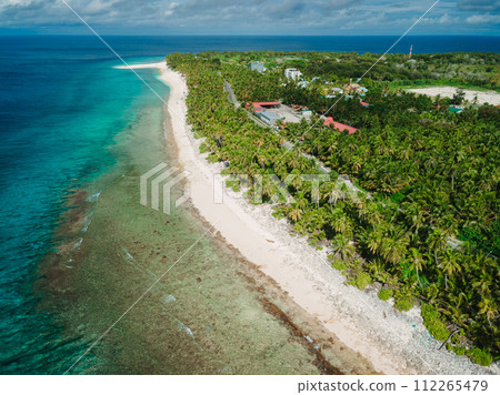 Maldives island beach with palms trees. Tropical banner. Aerial view Maldives island beach with palms trees. Tropical banner. Aerial view 112265479