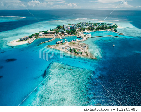 Gulhi island near Maafushi on Kaafu Atoll. Local island with blue ocean on Maldives. Aerial View Gulhi island near Maafushi on Kaafu Atoll. Local island with blue ocean on Maldives. Aerial View 112265483