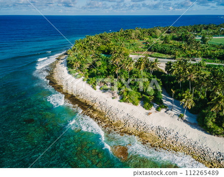 Maldives island ocean beach with palms trees. Tropical banner. Aerial view Maldives island ocean beach with palms trees. Tropical banner. Aerial view 112265489