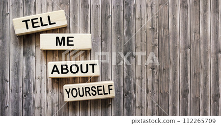 Wooden blocks with the inscription Tell me about yourself. Wooden blocks with the inscription Tell me about yourself. 112265709