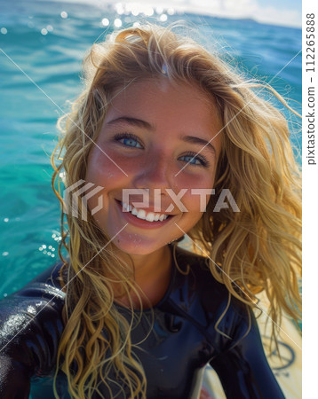Woman athlete with surfboard among the waves on the beach, sport concept 112265888