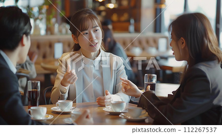 Coffee break. Group of young people sitting in a cafe and drinking coffee 112267537