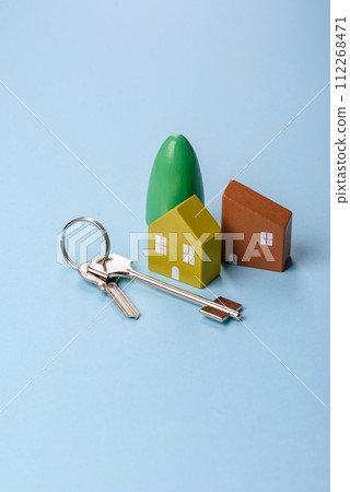 A small wooden house and keys as an idea for investing in your own home 112268471