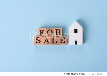A small wooden house and keys as an idea for investing in your own home A small wooden house and keys as an idea for investing in your own home 112268473