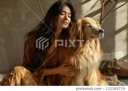 A woman is sitting on the floor with a golden retriever 112268719