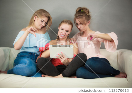 Three women using tablet Three women using tablet 112270613