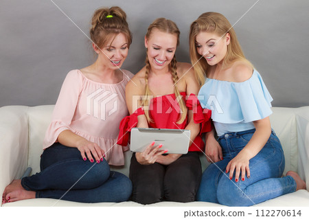 Three women using tablet 112270614